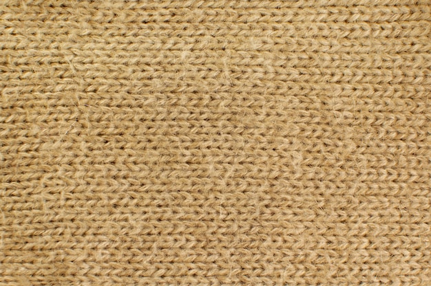 La trama di un plaid di lana lavorato a maglia con uno sfondo solido