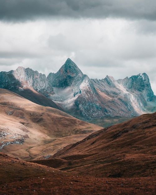 La vista panoramica delle montagne contro un cielo nuvoloso