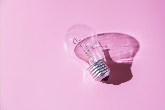 Lampada con ombra dura su sfondo rosa Simbolo della luce idea creativa