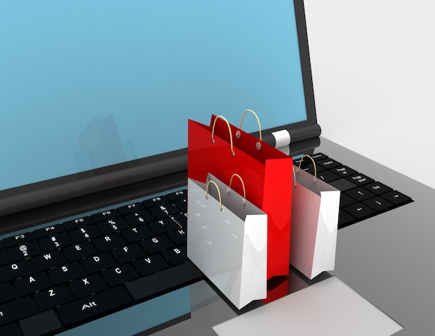 Laptop e pagine dello shopping su sfondo bianco