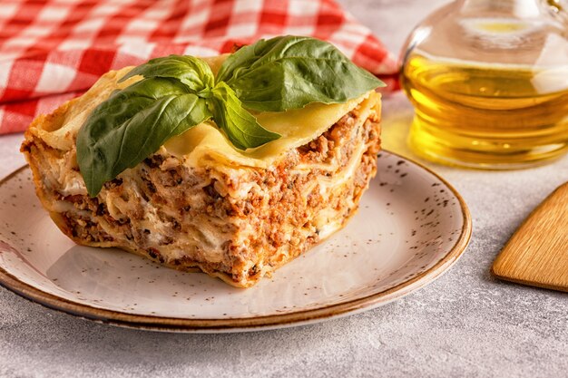 Lasagna tradizionale a base di ragù bolognese di manzo tritato e besciamella condita con foglie di basilico.