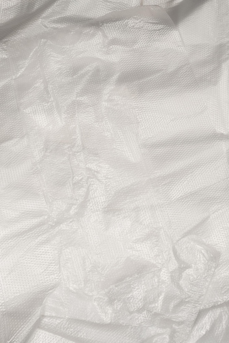 Photo latar belakang putih plastik, tampilan atas, ruang salin
