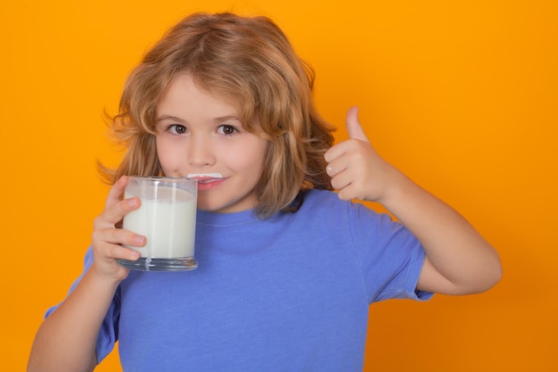 Latte da latte Bambino che beve latte Capretto con un bicchiere di latte su sfondo giallo isolato