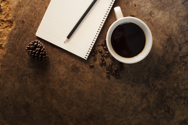 Lavorando con quaderni e tazze da caffè su pavimenti in legno.