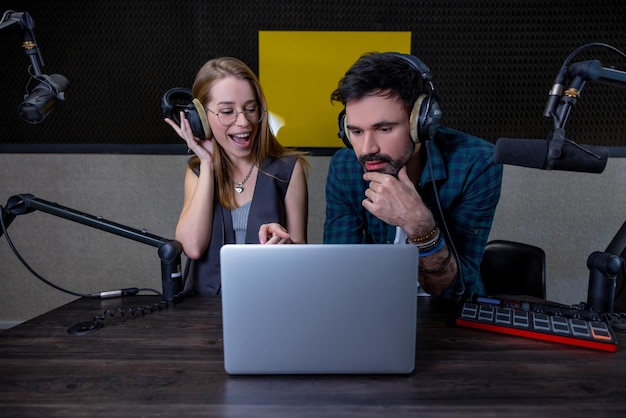 Lavorare in radio. Due membri del team fanno un sound check e sembrano coinvolti