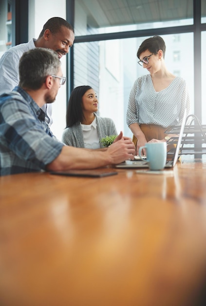 Lavorare insieme per portare a termine il compito Inquadratura di uomini d'affari che lavorano insieme in ufficio