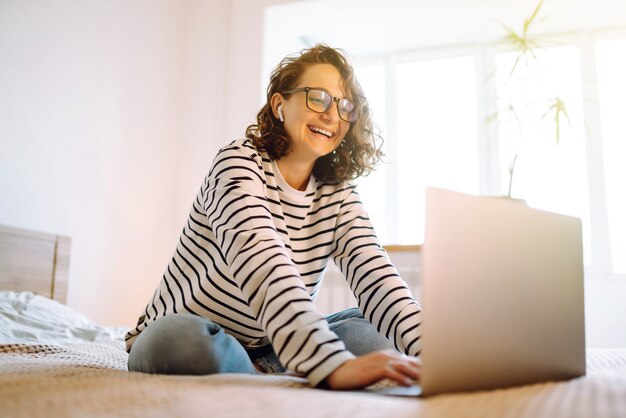 Lavorare online Giovane libera professionista seduta a casa e lavorare al computer portatile Shopping online