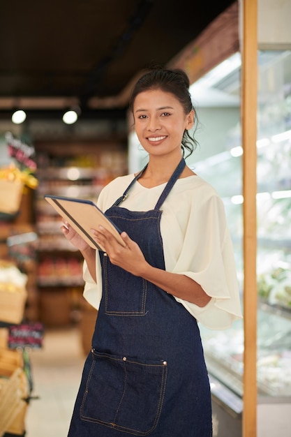 Lavoratore del supermercato che controlla gli ordini online