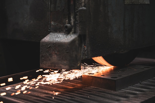 Lavorazione industriale di metallo, smerigliatrice con scintille.