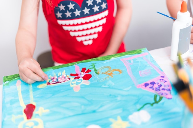 Le bambine dipingono su tela la festa del 4 luglio.