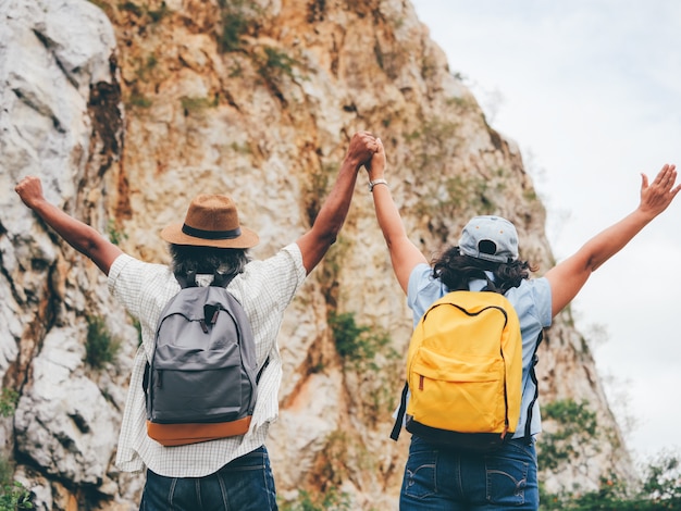 Le coppie senior viaggiano su vacanze estive. si tengono per mano e camminano insieme.