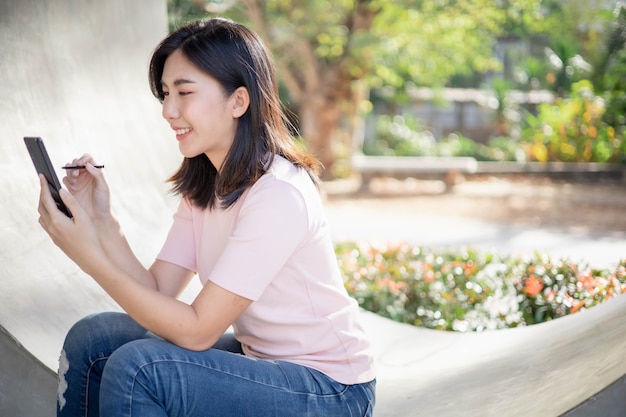 Le donne asiatiche lavorano e ascoltano musica sui telefoni cellulari.