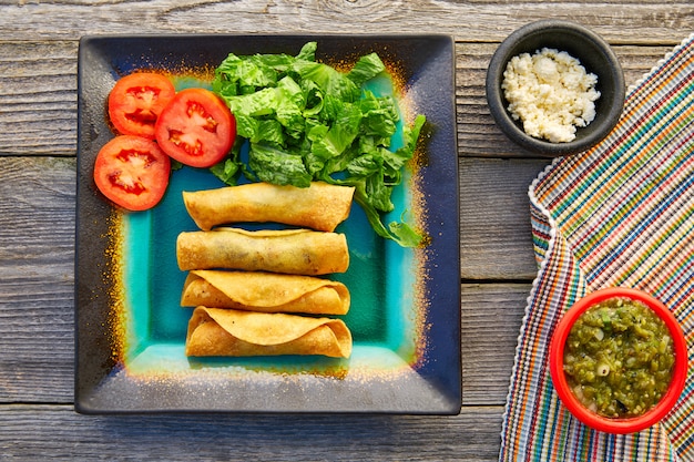 Le flautas messicane arrotolate i tacos con salsa