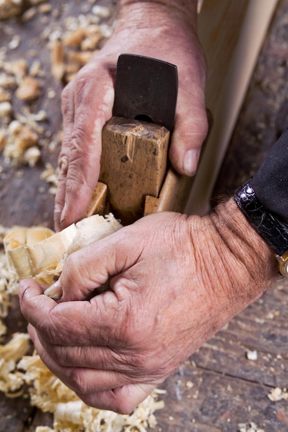 Le foto delle mani maschili sono realizzate con una pialla di legno