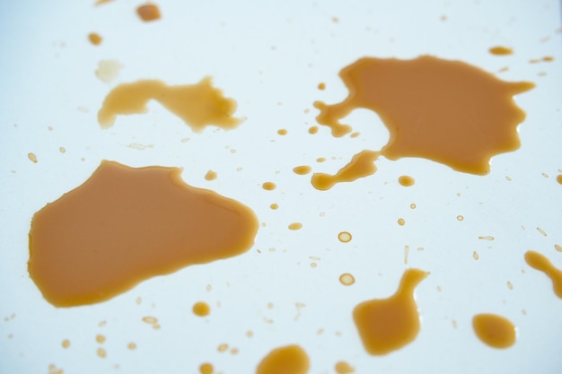 Le macchie di caffè su una superficie bianca creano un disegno astratto