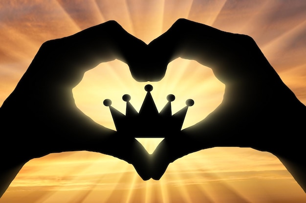 Le mani di un uomo tengono una corona, mostrando che gli piace questo simbolo del cuore. Il concetto di narcisismo ed egoismo