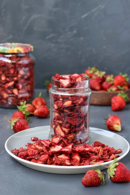 Le patatine alla fragola sono in un barattolo di vetro su una superficie scura, prodotti finiti, cibo sano