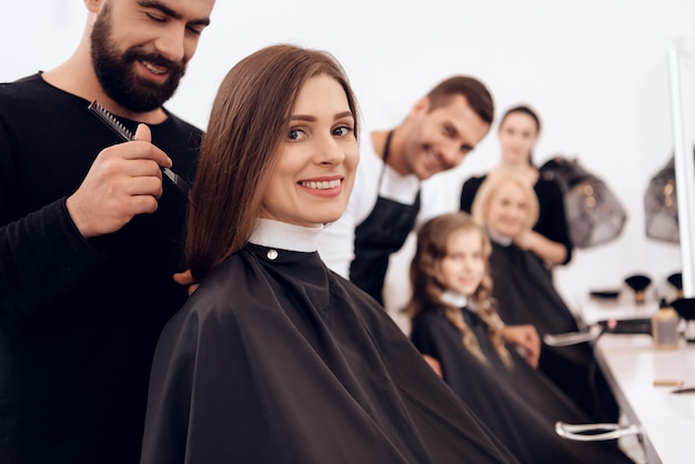 Le ragazze fanno acconciature in parrucchiere. Taglio di capelli femminile