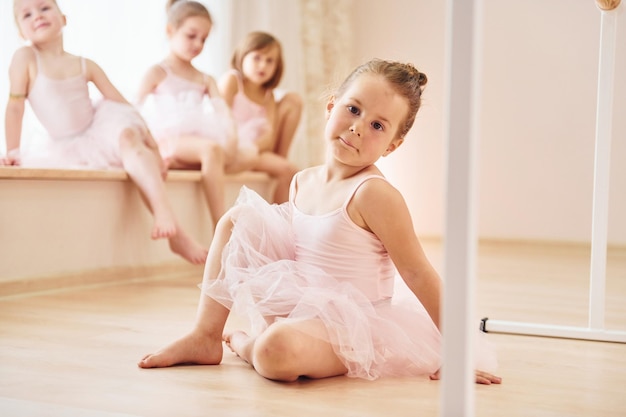 Le ragazze si siedono sul davanzale e sul pavimento Piccole ballerine che si preparano per la performance