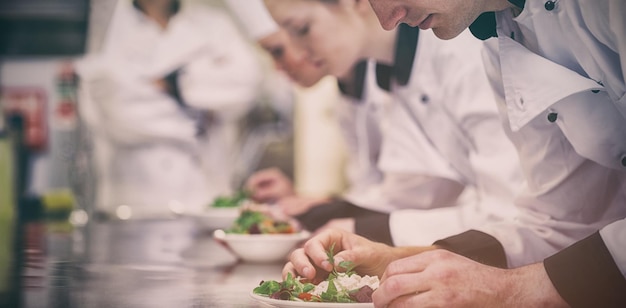 Lezione di cucina in cucina che prepara insalate mentre l'insegnante si affaccia