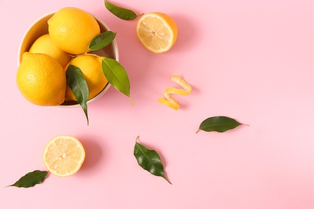 Limoni e foglie verdi su sfondo colorato