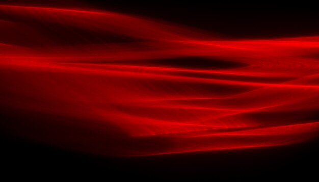 Linee rosse astratte disegnate dalla luce su sfondo nero. Linee laser