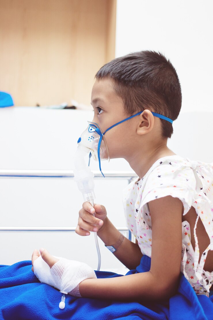 Little boy with inhalator mask in hospital