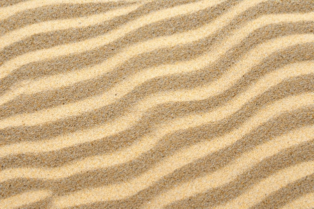 Lo sfondo incantevole di sabbia con un motivo affascinante