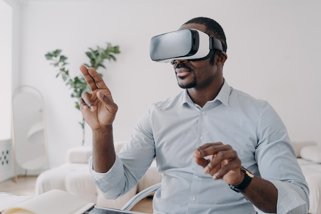 Lo sviluppatore di uomini afroamericani con occhiali VR utilizza il software di modellazione della realtà virtuale Future high tech