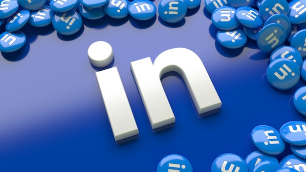 Logo di linkedin 3D su uno sfondo blu circondato da molte pillole lucide di linkedin