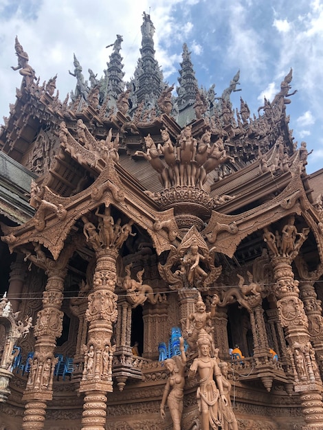 Low angle view of temple with sculpture against sky