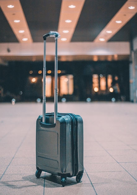 Luggage on footpath against airport