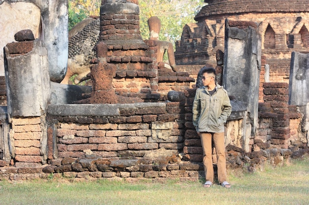 Lunghezza completa di un uomo in piedi contro le vecchie rovine del tempio