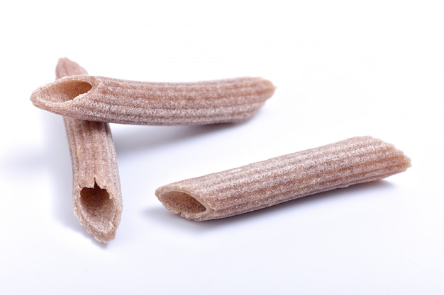 Maccheroni del grano saraceno della pasta su fondo bianco