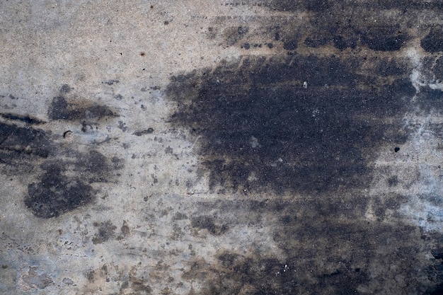 Macchie di olio d'auto che gocciolano sul pavimento di cemento olio del motore d'auto cemento pavimento sporcizia vecchia vista dall'alto
