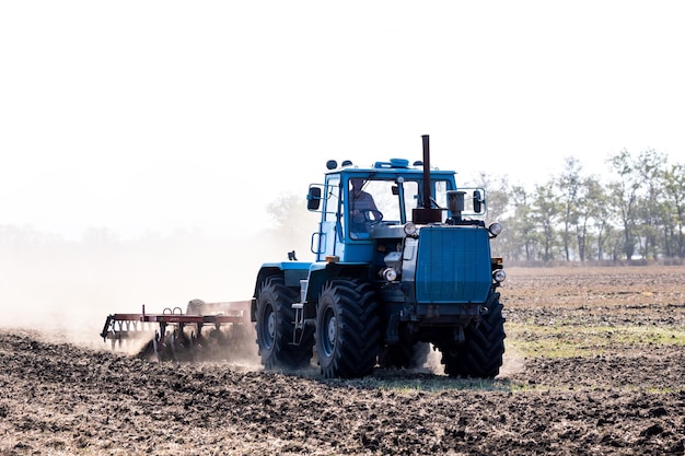 Macchine agricole in primo piano che lavorano nel campo