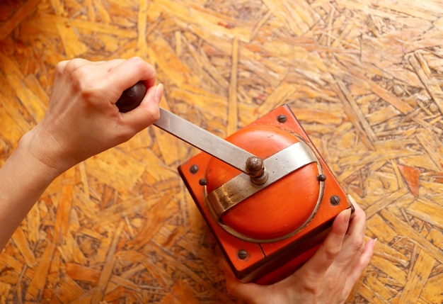 Macinare a mano i chicchi di caffè nel macinino da caffè portatile retrò per caffè fatto in casa