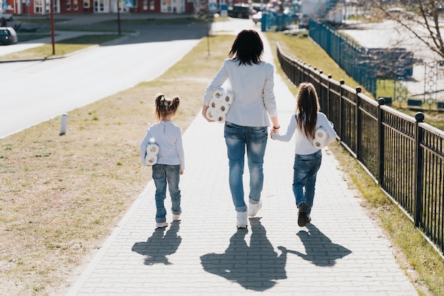 Madre con bambini che camminano con la carta igienica dal supermercato