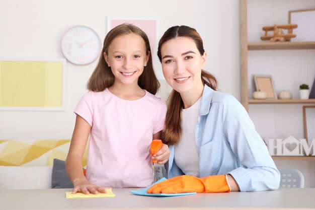 Madre e figlia di buon umore stanno pulendo la casa