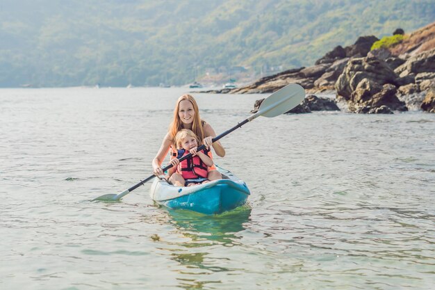 Madre e figlio in kayak nell'oceano tropicale