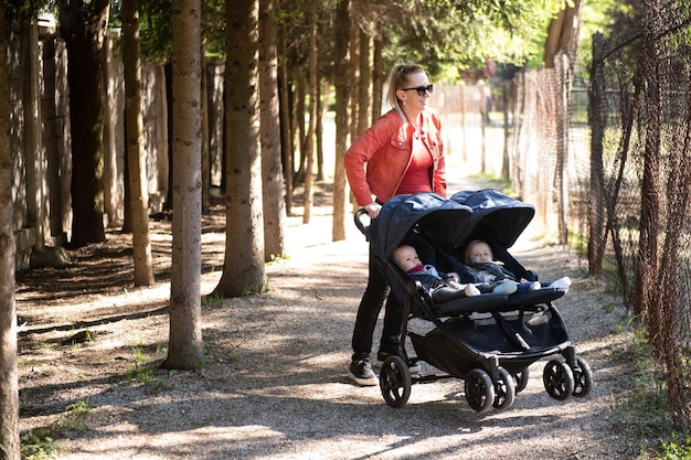 Madre felice con il passeggino nel parco