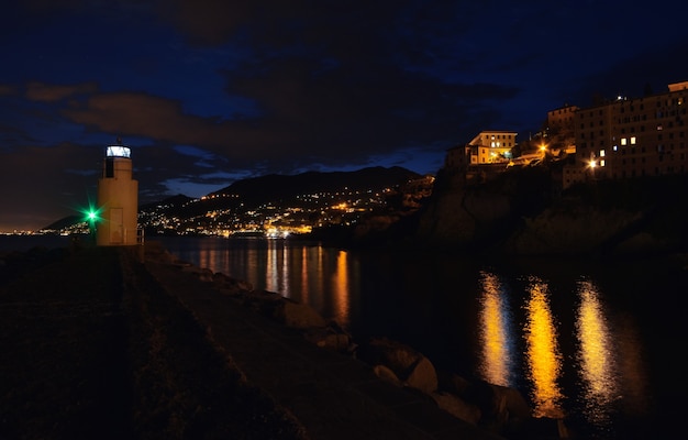 Magnifica veduta del faro di Camogli luci e colori si riflettono sul mare creando un