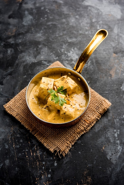 Malai o achari Paneer in un sugo fatto con panna da montare. servito su un piatto da portata. messa a fuoco selettiva