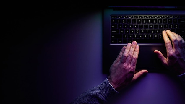 Male hands are typing on a laptop keyboard