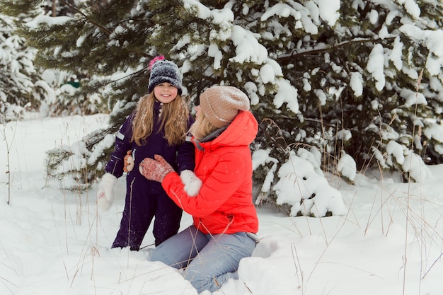 mamma e figlia che giocano nella neve divertimento invernale in famiglia