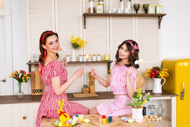 Mamma e figlia festeggiano la Pasqua La famiglia è di casa nella cucina addobbata per Pasqua