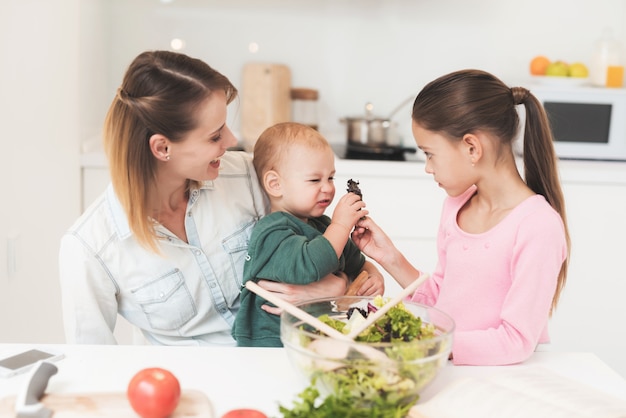 Mamma e figlia si divertono mentre si prepara un'insalata.