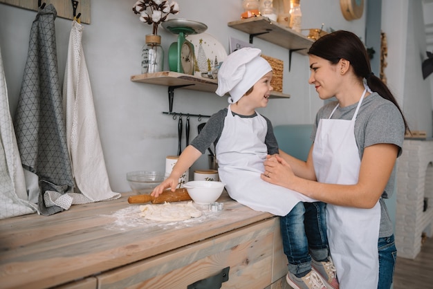 mamma e ragazzo che preparano la pasta per i biscotti di Natale