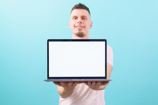 man holding a laptop with two hands and presenting something on an empty blank screen