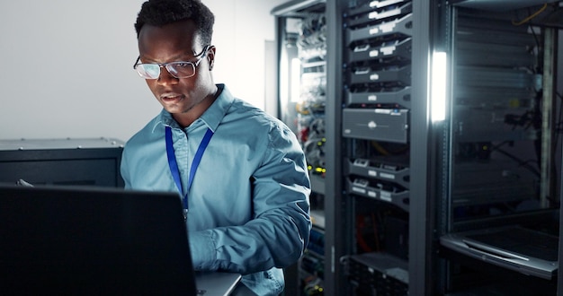 Man laptop and engineer working in server room firmwear update and programmer for cyber security Developer confident and IT support or upgrade network for gdpr database and data centre with tech